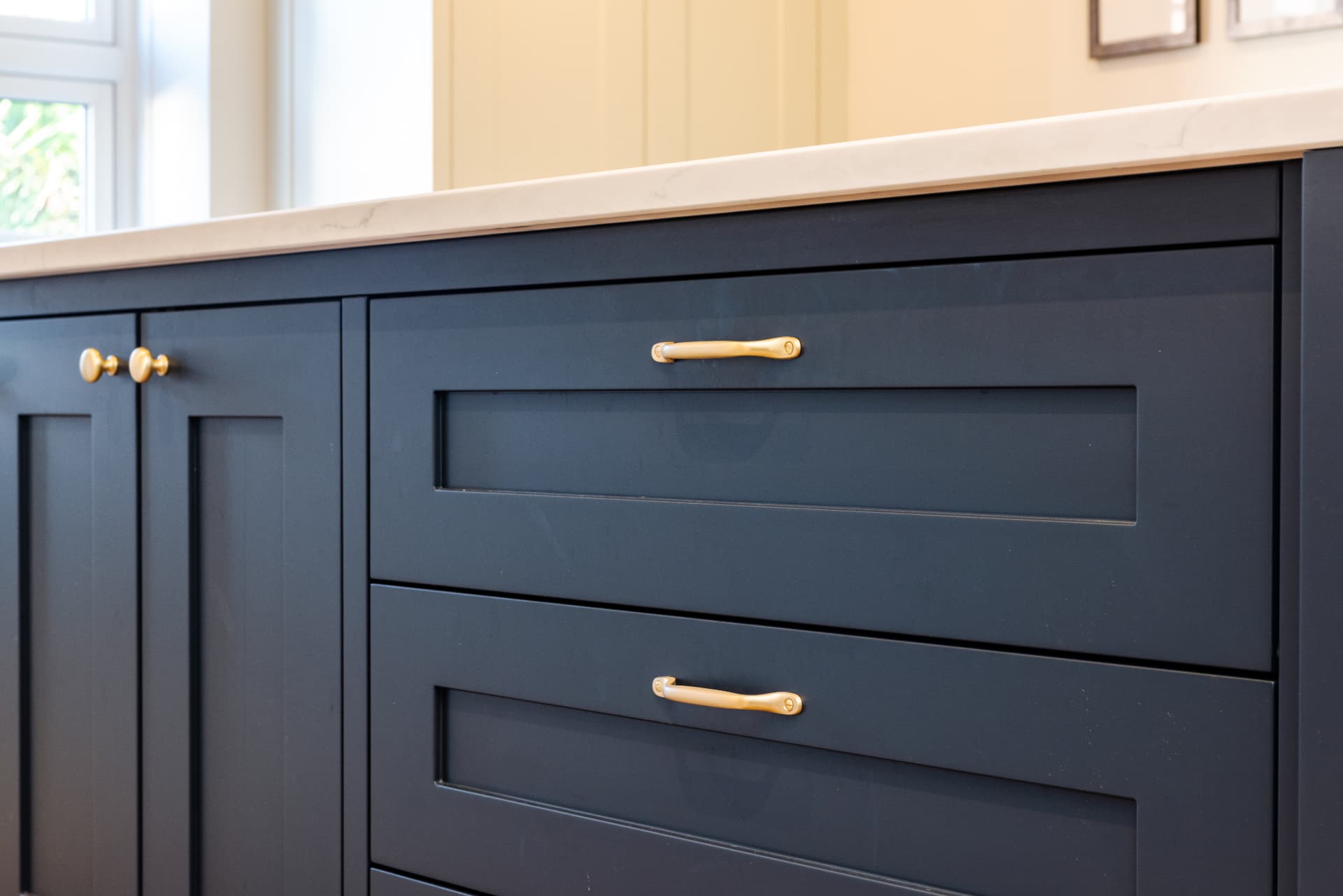 Navy shaker kitchen cabinets with brass handles